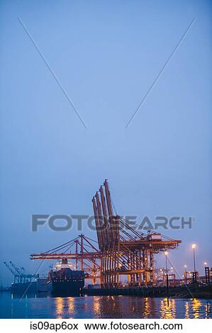 "View of container ship and gantry cranes in harbor at night, Tacoma, Washington, USA" View Large Photo Image Stock Photo - "View of container ship and gantry cranes in harbor at night, Tacoma, Washington, USA". Fotosearch