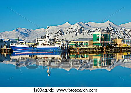 "View of harbor fishing boats and snow covered mountains, Hofn, Iceland" View Large Photo Image Stock Photography - "View of harbor fishing boats and snow covered mountains, Hofn, Iceland". Fotosearch