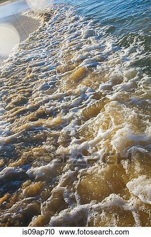 Waves slowing down in foams on shore View Large Photo Image Stock Image - Waves slowing down in foams on shore. Fotosearch