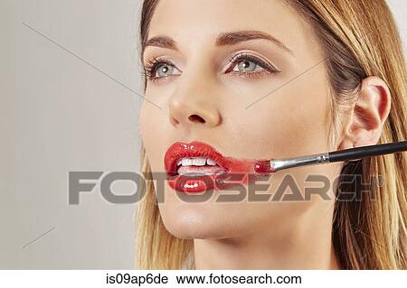 Woman applying lipstick badly View Large Photo Image Stock Image - Woman applying lipstick badly. Fotosearch