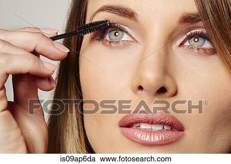Woman applying mascara View Large Photo Image Stock Image - Woman applying mascara. Fotosearch