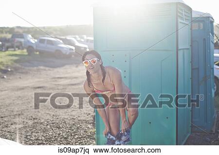 Stock Photography - Woman by changing room on beach. Fotosearch