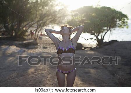 Stock Photograph - Woman enjoying beach. Fotosearch