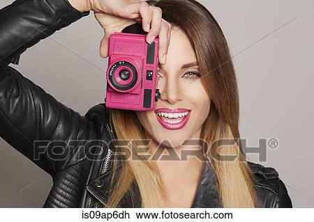 Woman holding up camera to eye View Large Photo Image Stock Image - Woman holding up camera to eye. Fotosearch