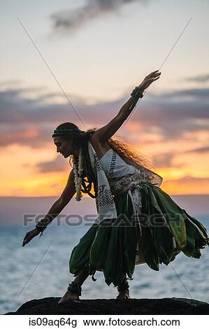 "Woman hula dancing on coastal rocks wearing traditional costume at sunset, Maui, Hawaii, USA" View Large Photo Image Stock Image - "Woman hula dancing on coastal rocks wearing traditional costume at sunset, Maui, Hawaii, USA". Fotosearch
