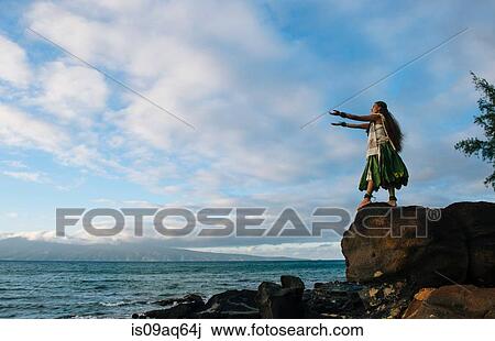 "Woman hula dancing on top of coastal rocks wearing traditional costume, Maui, Hawaii, USA" View Large Photo Image Stock Image - "Woman hula dancing on top of coastal rocks wearing traditional costume, Maui, Hawaii, USA". Fotosearch