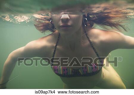 Woman swimming in water View Large Photo Image Picture - Woman swimming in water. Fotosearch