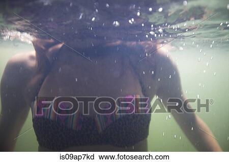 Stock Image - Woman swimming in water. Fotosearch