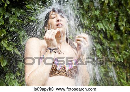 "Woman swimming, wall of leaves in background" View Large Photo Image Stock Image - "Woman swimming, wall of leaves in background". Fotosearch
