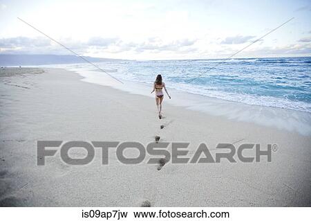 Woman walking on beach View Large Photo Image Stock Photo - Woman walking on beach. Fotosearch