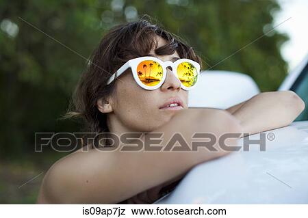 Woman wearing sunglasses reflecting palm trees View Large Photo Image Stock Photo - Woman wearing sunglasses reflecting palm trees. Fotosearch