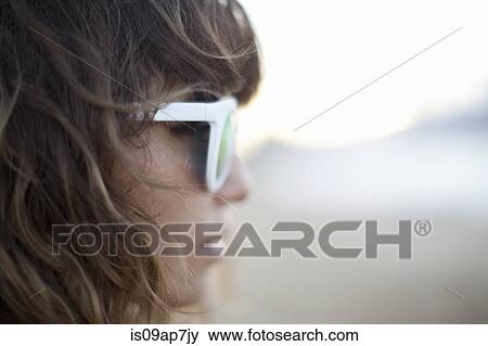Stock Photo - Woman wearing sunglasses. Fotosearch