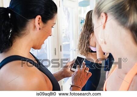 Stock Image - Women using smartphone. Fotosearch