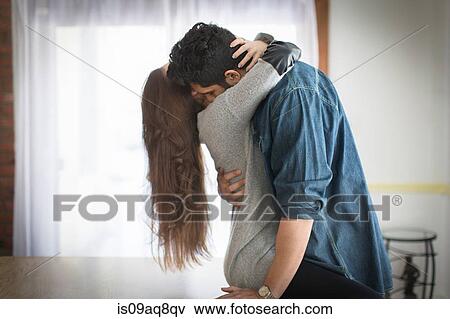 Stock Photo - Young couple hugging. Fotosearch