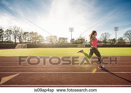 Young female athlete running on race track View Large Photo Image Stock Photography - Young female athlete running on race track. Fotosearch