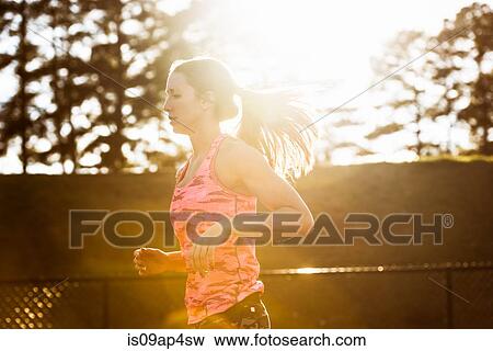 Young female athlete running on track View Large Photo Image Stock Photo - Young female athlete running on track. Fotosearch