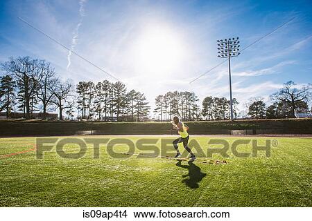 Young female athlete stepping between agility ladder on sports field View Large Photo Image Picture - Young female athlete stepping between agility ladder on sports field. Fotosearch