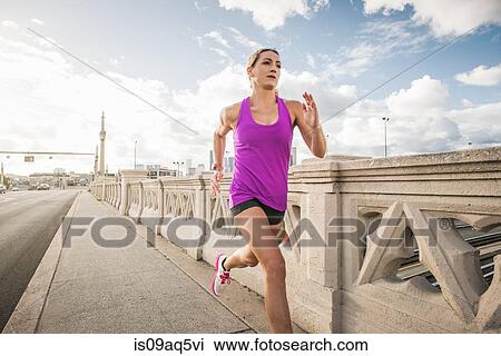 "Young female runner running across bridge, Los Angeles, California, USA" View Large Photo Image Stock Image - "Young female runner running across bridge, Los Angeles, California, USA". Fotosearch
