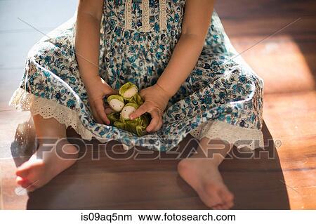 "Young girl, sitting on floor, playing with toy, low section" View Large Photo Image Picture - "Young girl, sitting on floor, playing with toy, low section". Fotosearch