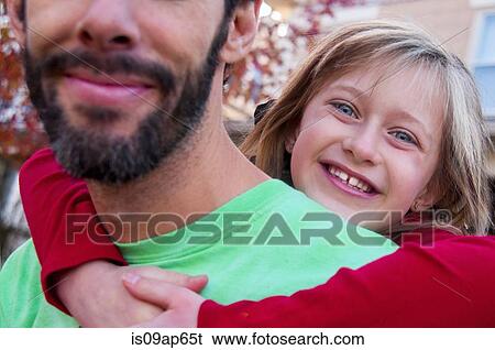 Young girl with arms around father's neck View Large Photo Image Stock Photograph - Young girl with arms around father's neck. Fotosearch