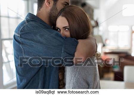 Young man hugging woman View Large Photo Image Stock Photograph - Young man hugging woman. Fotosearch