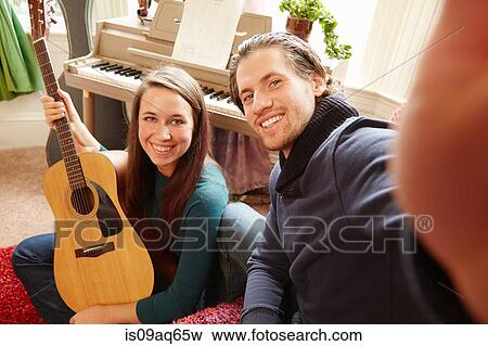 Young man taking selfie with guitarist girlfriend View Large Photo Image Stock Photo - Young man taking selfie with guitarist girlfriend. Fotosearch