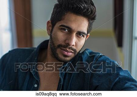 Stock Photography - "Young man wearing denim shirt, portrait". Fotosearch