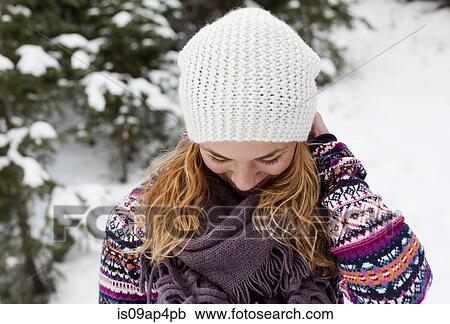 Young woman giggling in front of snow covered fir trees View Large Photo Image Stock Image - Young woman giggling in front of snow covered fir trees. Fotosearch
