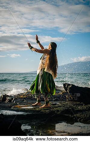 "Young woman hula dancing on coastal rocks wearing traditional costume, Maui, Hawaii, USA" View Large Photo Image Stock Image - "Young woman hula dancing on coastal rocks wearing traditional costume, Maui, Hawaii, USA". Fotosearch