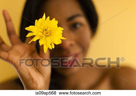 Stock Photo - Young woman posing with flower. Fotosearch