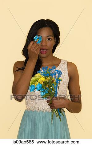Stock Photography - Young woman posing with flowers. Fotosearch