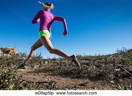 Stock Photography - "Young woman trail running on Pacific Crest Trail, Pine Valley, California, USA". Fotosearch