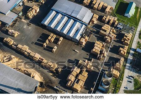 Stock Photo - Aerial view of stacked planks in timber yard. Fotosearch