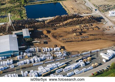 Aerial view of stacked tree trunks and warehouses in timber yard View Large Photo Image Stock Photo - Aerial view of stacked tree trunks and warehouses in timber yard. Fotosearch