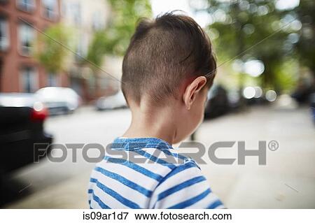 Stock Photo - Back view of boy walking down street. Fotosearch