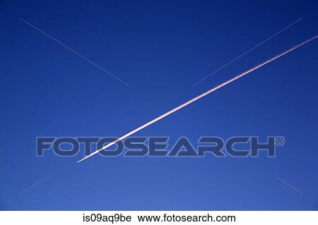 Blue sky and diagonal airplane vapor trail View Large Photo Image Stock Image - Blue sky and diagonal airplane vapor trail. Fotosearch