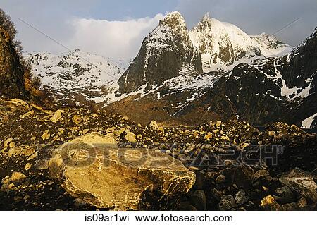 "Boulder, rocks and snow capped mountain, Reine, Lofoten, Norway" View Large Photo Image Stock Image - "Boulder, rocks and snow capped mountain, Reine, Lofoten, Norway". Fotosearch