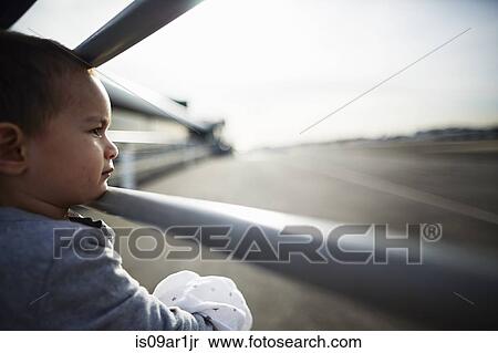 Stock Photography - Boy looking out between railings. Fotosearch
