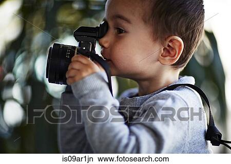 Boy taking photograph with camera View Large Photo Image Picture - Boy taking photograph with camera. Fotosearch