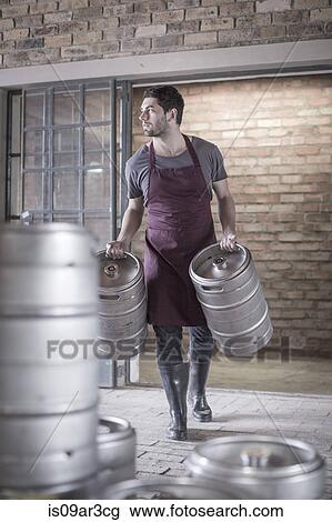Brewer carrying two kegs of beer View Large Photo Image Stock Image - Brewer carrying two kegs of beer. Fotosearch