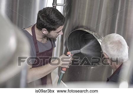 Brewer cleaning out a stainless steel tank in the brewery View Large Photo Image Stock Photo - Brewer cleaning out a stainless steel tank in the brewery. Fotosearch