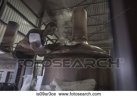 Brewer looking into brewing machine View Large Photo Image Stock Image - Brewer looking into brewing machine. Fotosearch