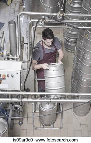 Brewer moving kegs in brewery View Large Photo Image Stock Image - Brewer moving kegs in brewery. Fotosearch