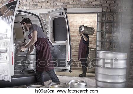 Stock Image - Brewers loading kegs into back of van. Fotosearch
