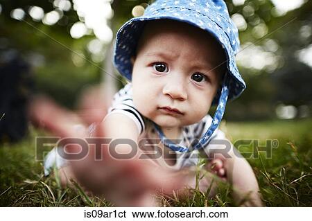 Close up of baby boy reaching out towards camera View Large Photo Image Stock Photograph - Close up of baby boy reaching out towards camera. Fotosearch