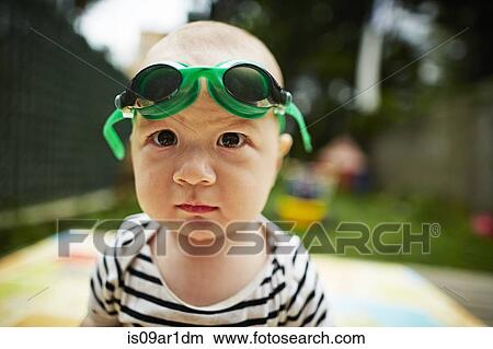 Close up portrait of baby boy looking at camera wearing swimming goggles View Large Photo Image Picture - Close up portrait of baby boy looking at camera wearing swimming goggles. Fotosearch