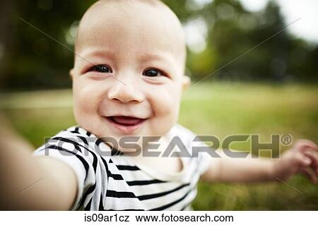 Close up portrait of baby boy smiling at camera View Large Photo Image Stock Photo - Close up portrait of baby boy smiling at camera. Fotosearch