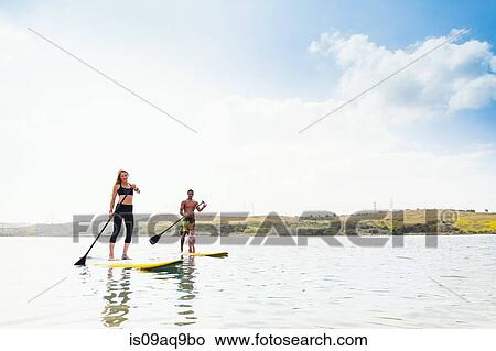 "Couple and toddler daughter standup paddleboarding on tranquil sea, Carlsbad, California, USA" View Large Photo Image Picture - "Couple and toddler daughter standup paddleboarding on tranquil sea, Carlsbad, California, USA". Fotosearch