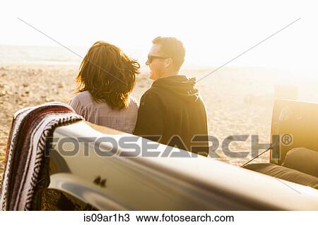 Stock Image - "Couple on beach, Malibu, California, USA". Fotosearch