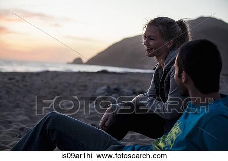 Stock Image - "Couple on beach, Malibu, California, USA". Fotosearch